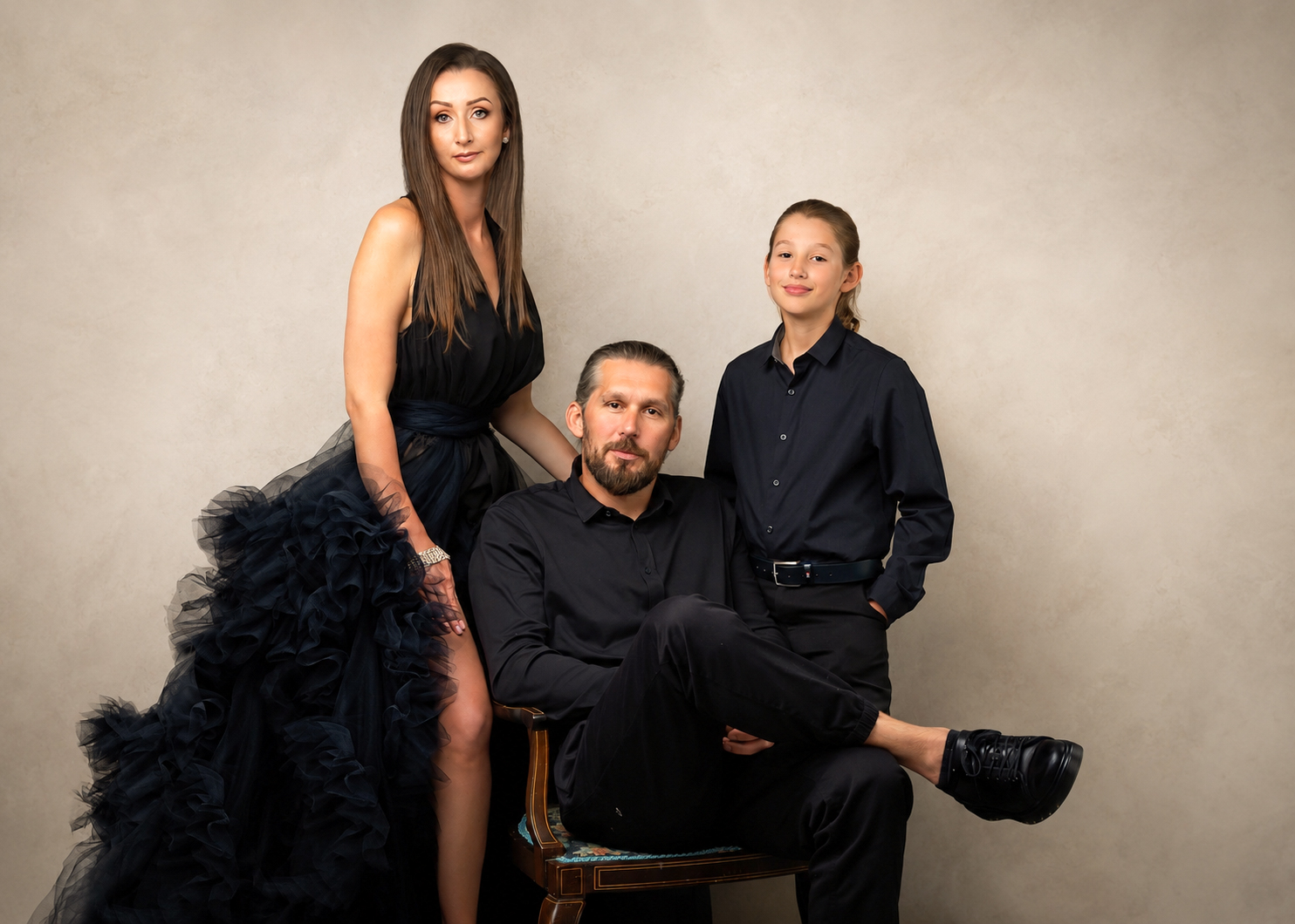 Elegant studio family portrait with parents and daughter