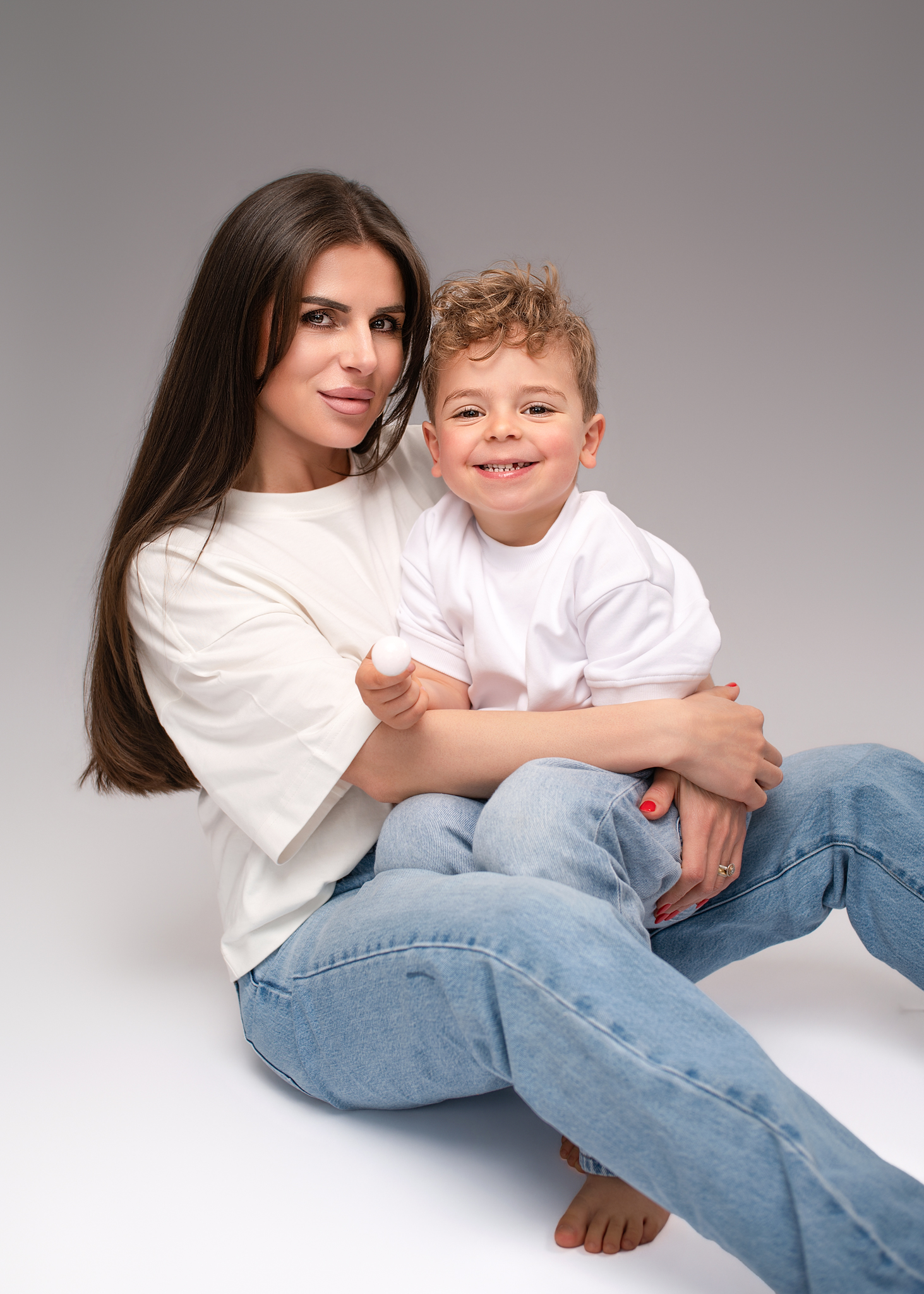 Mother and young son studio portrait