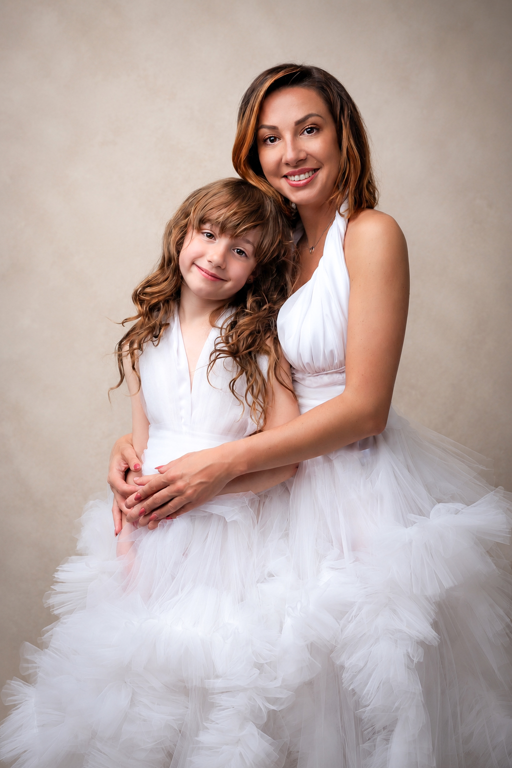 Mother and daughter portrait in matching white gowns