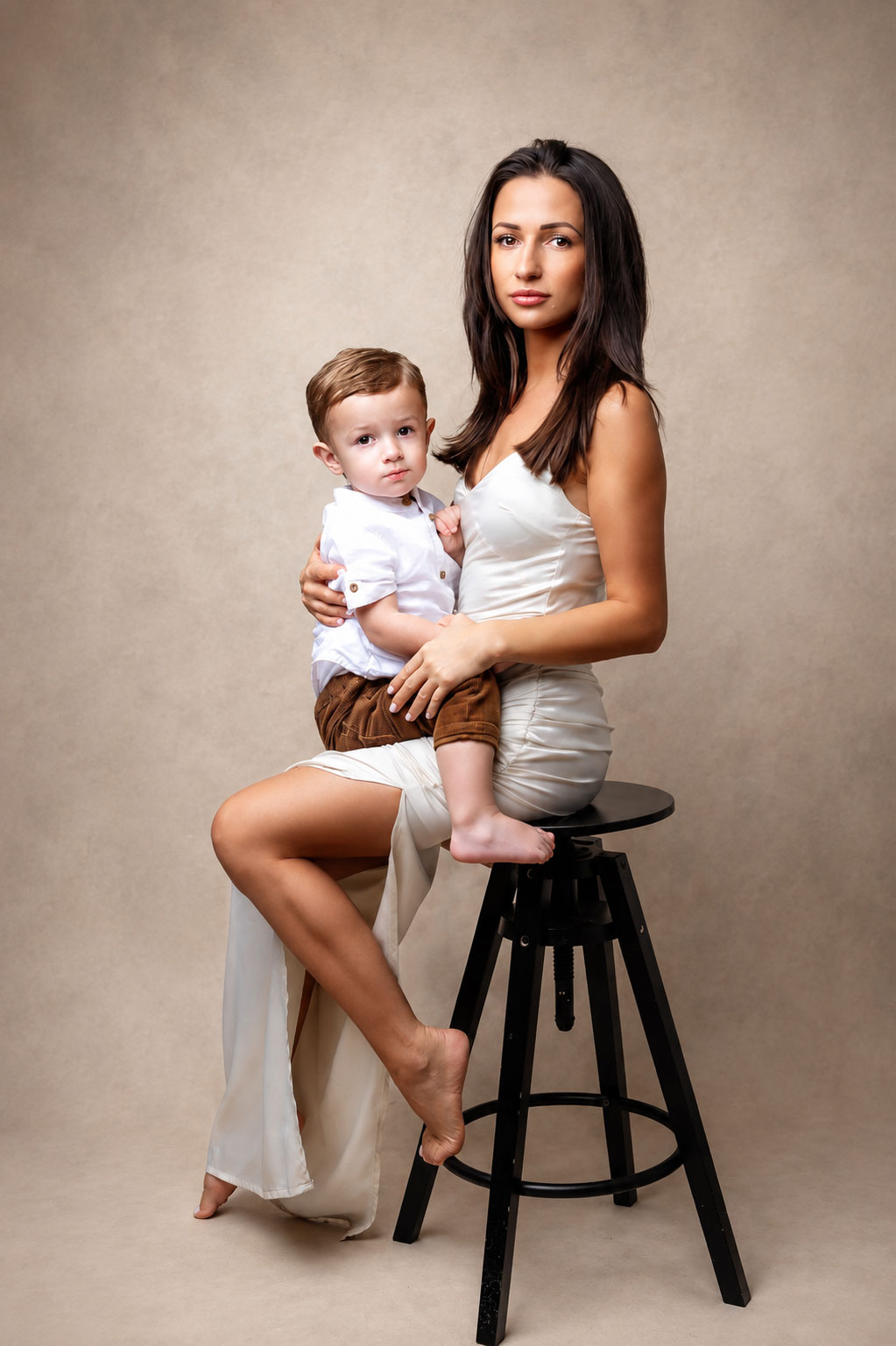 Mother holding her young son in a studio portrait