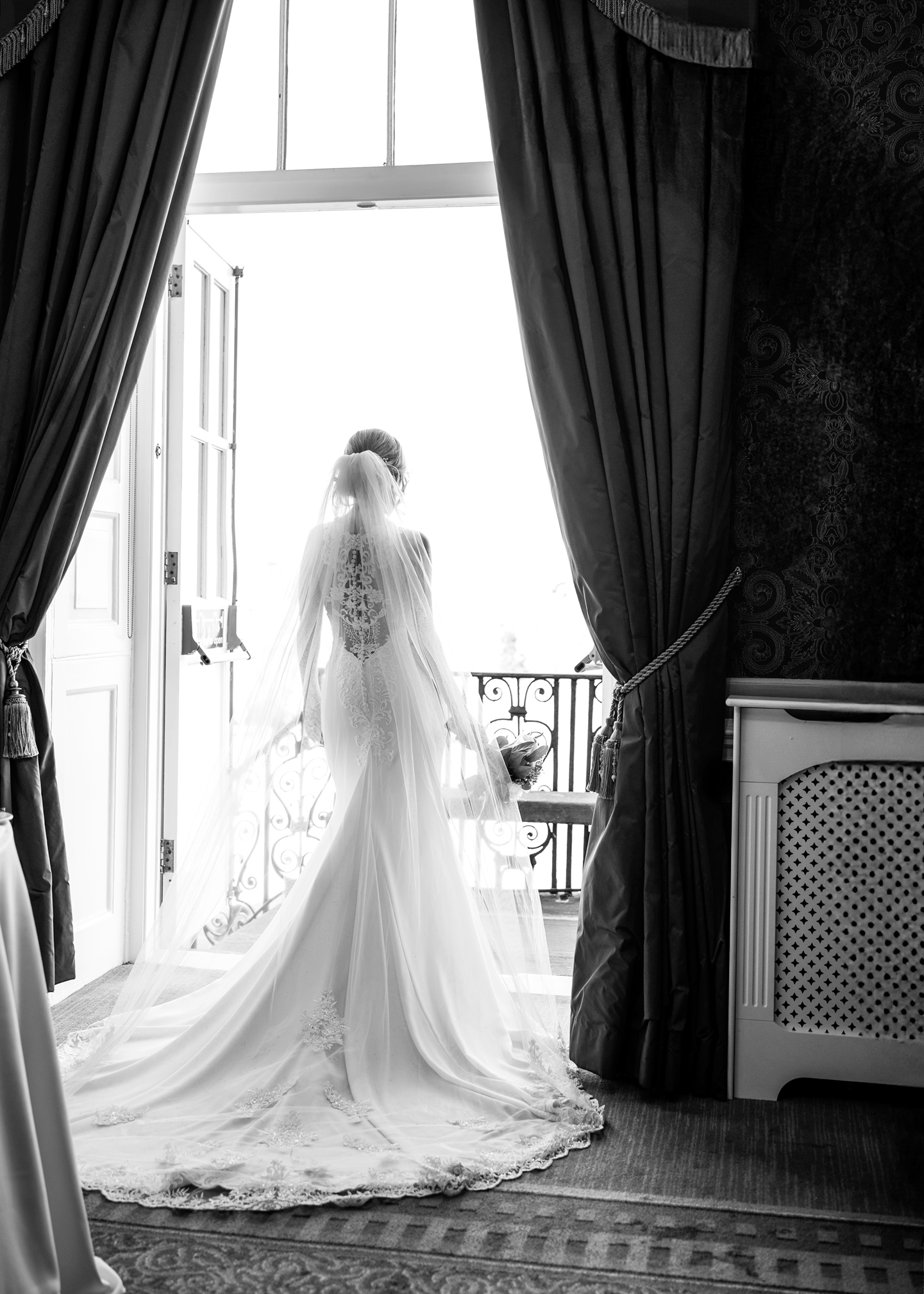 Black and white bridal portrait beside a bright window
