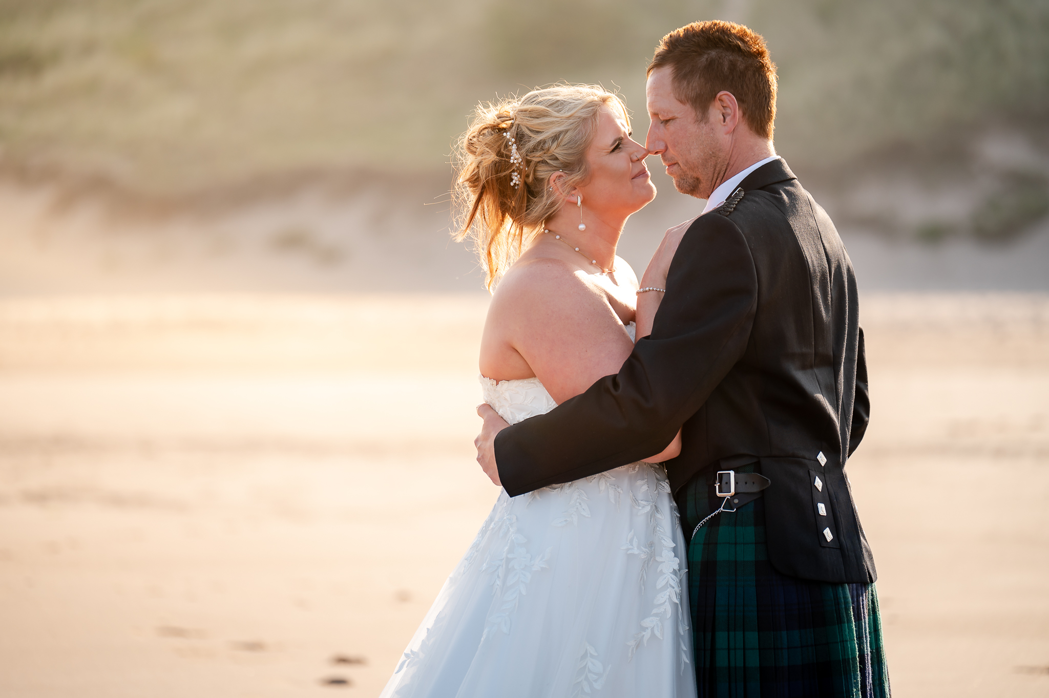 Wedding couple embracing on a Scottish beach