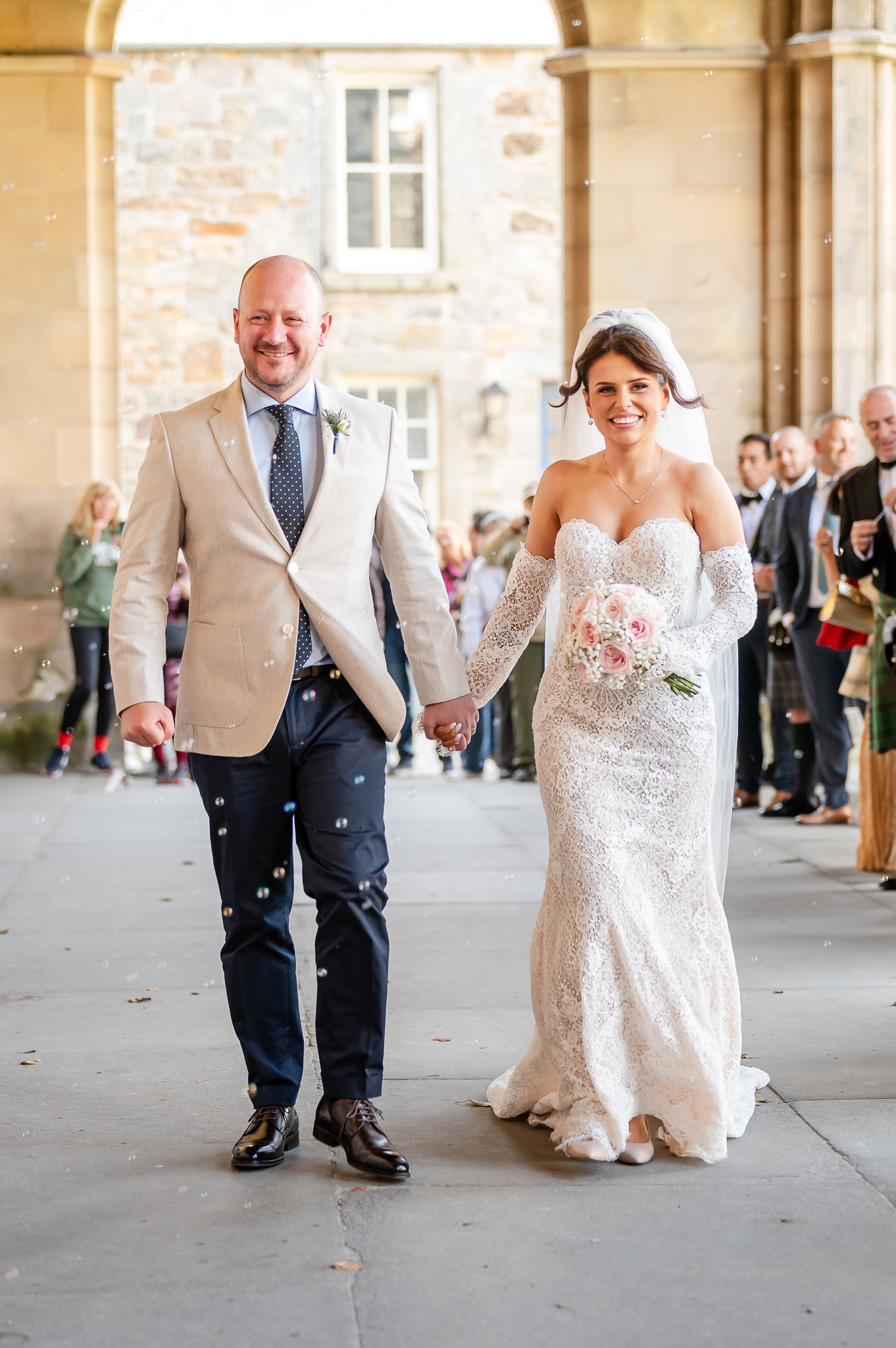Bride and groom celebrating outside their wedding venue