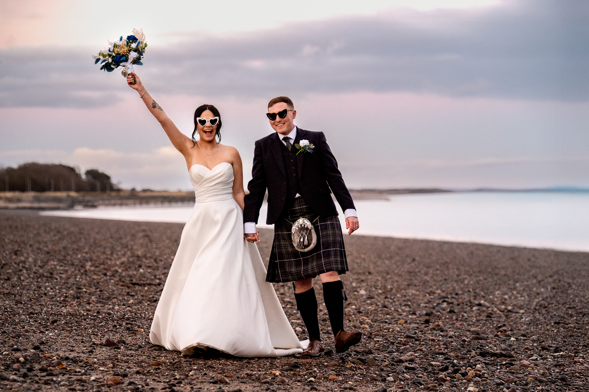 Wedding couple celebrating beside the Scottish coast