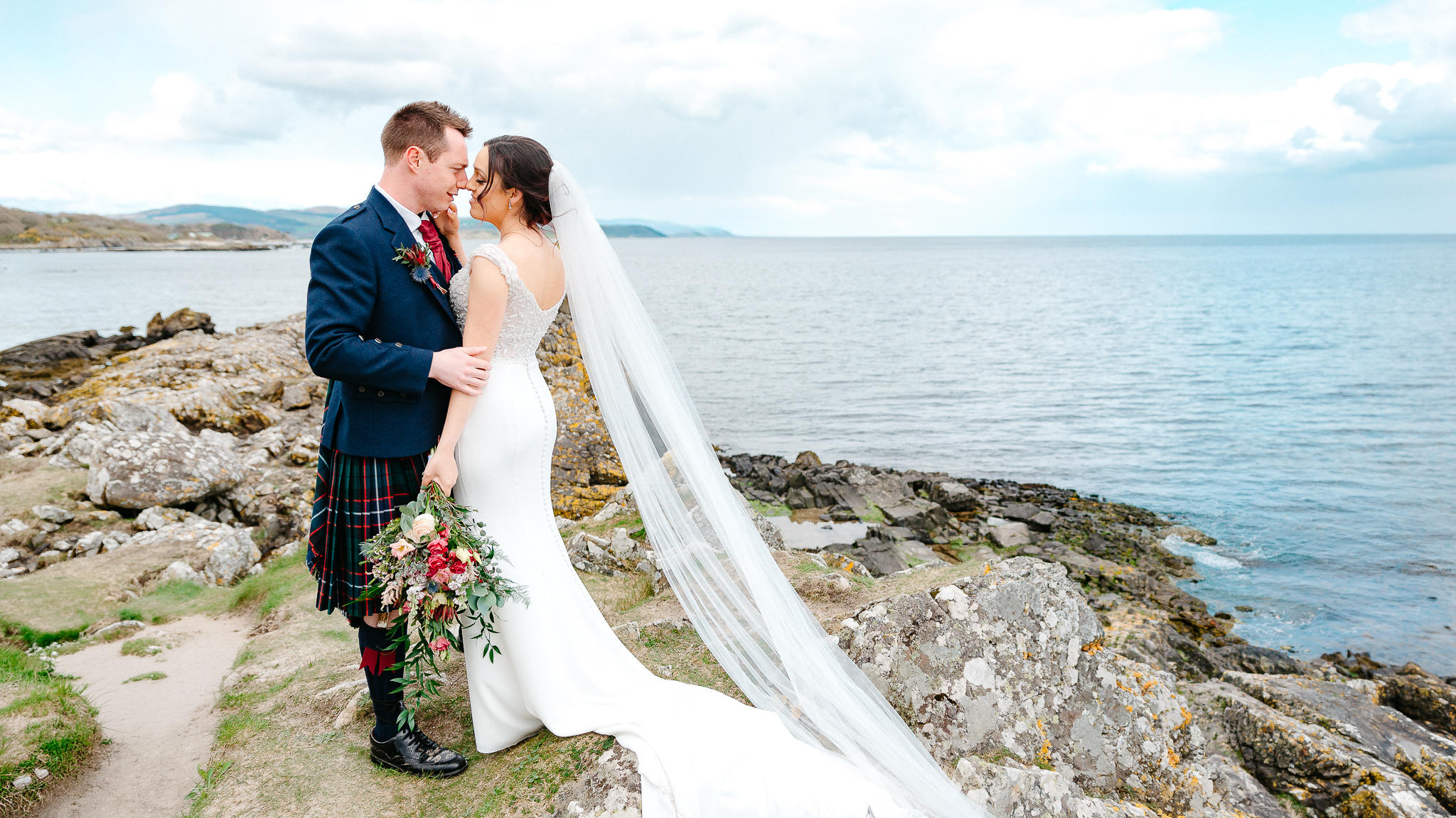 Bride and groom photographed beside the Scottish coast